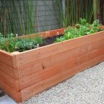 DIY raised garden planter made of wood, about 2 feet high and 6 feet long
