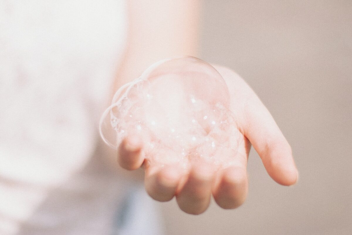 A hand holding soap bubbles
