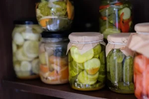 Six jars of varied homemade preserves in vinegars