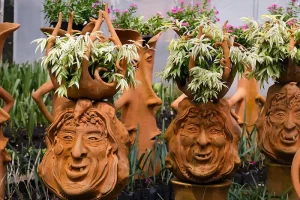 Ceramic Art of faces on plant containers  