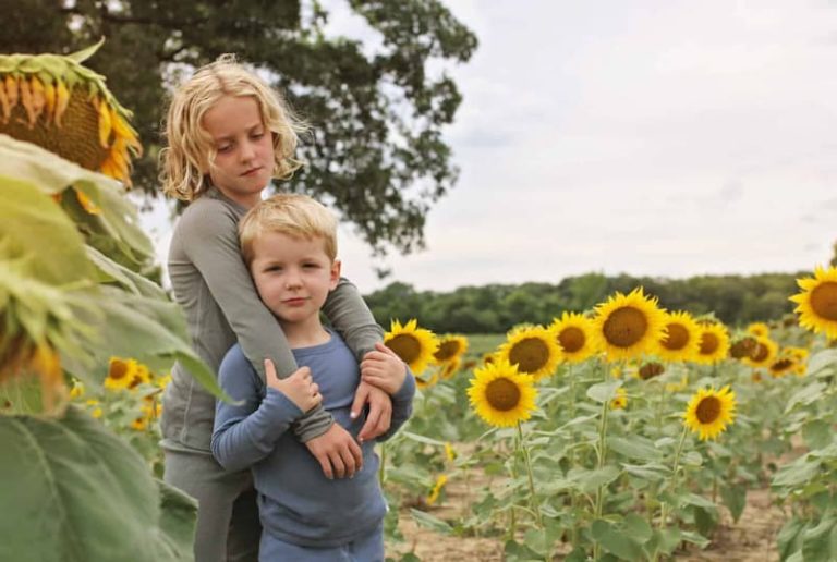 A young girl and boy in a sunflower field