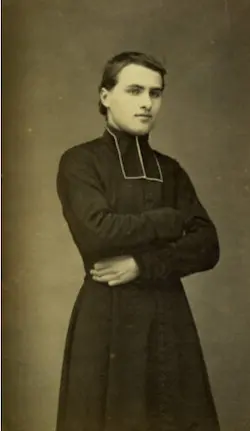 Vintage portrait of young priest with crossed arms